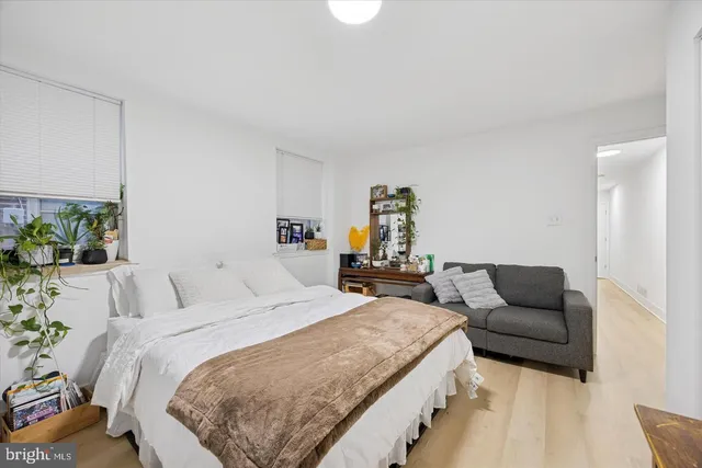 a bedroom with a bed and a couch