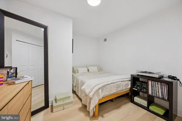 a bedroom with a bed and a dresser