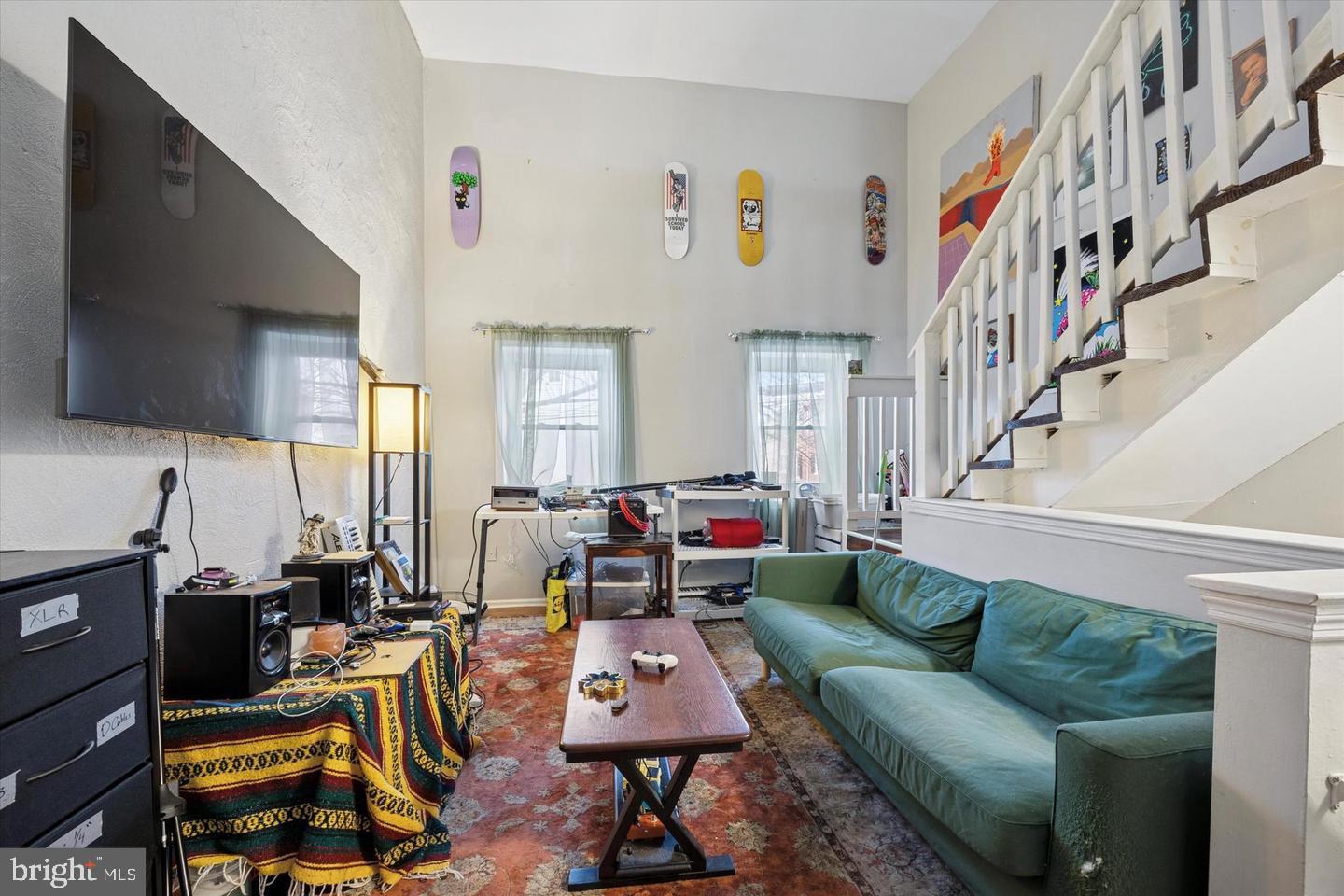 1228 South 2nd Street Philadelphia, PA 19147 - Photo 25 of 35 a living room with furniture kitchen view and a flat screen tv