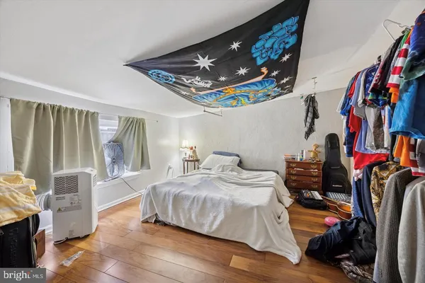 a bedroom with bed and a window
