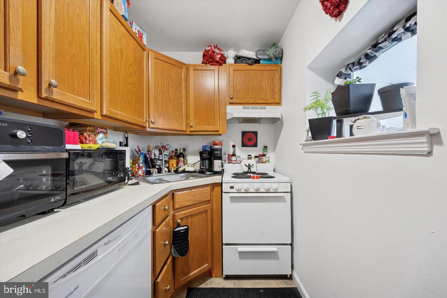 1228 South 2nd Street Philadelphia, PA 19147 - Photo 4 of 35 a kitchen with stainless steel appliances granite countertop a sink dishwasher and cabinets with wooden floor