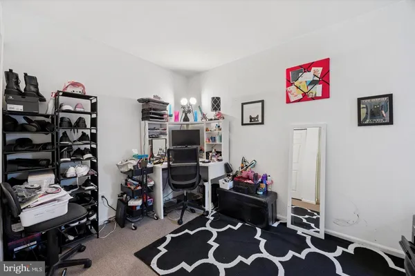 a bedroom with furniture and a chair