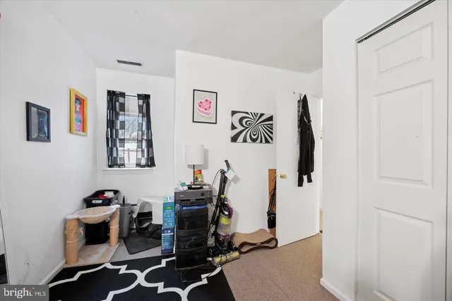 a view of a workspace with furniture and gym equipment