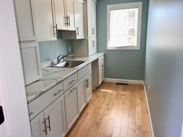 a kitchen with sink stove and cabinets
