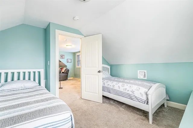 a bedroom with a bed lamp and a bathroom