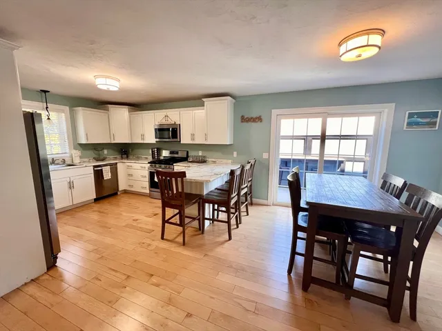 a view of a dining room with furniture and a kitchen