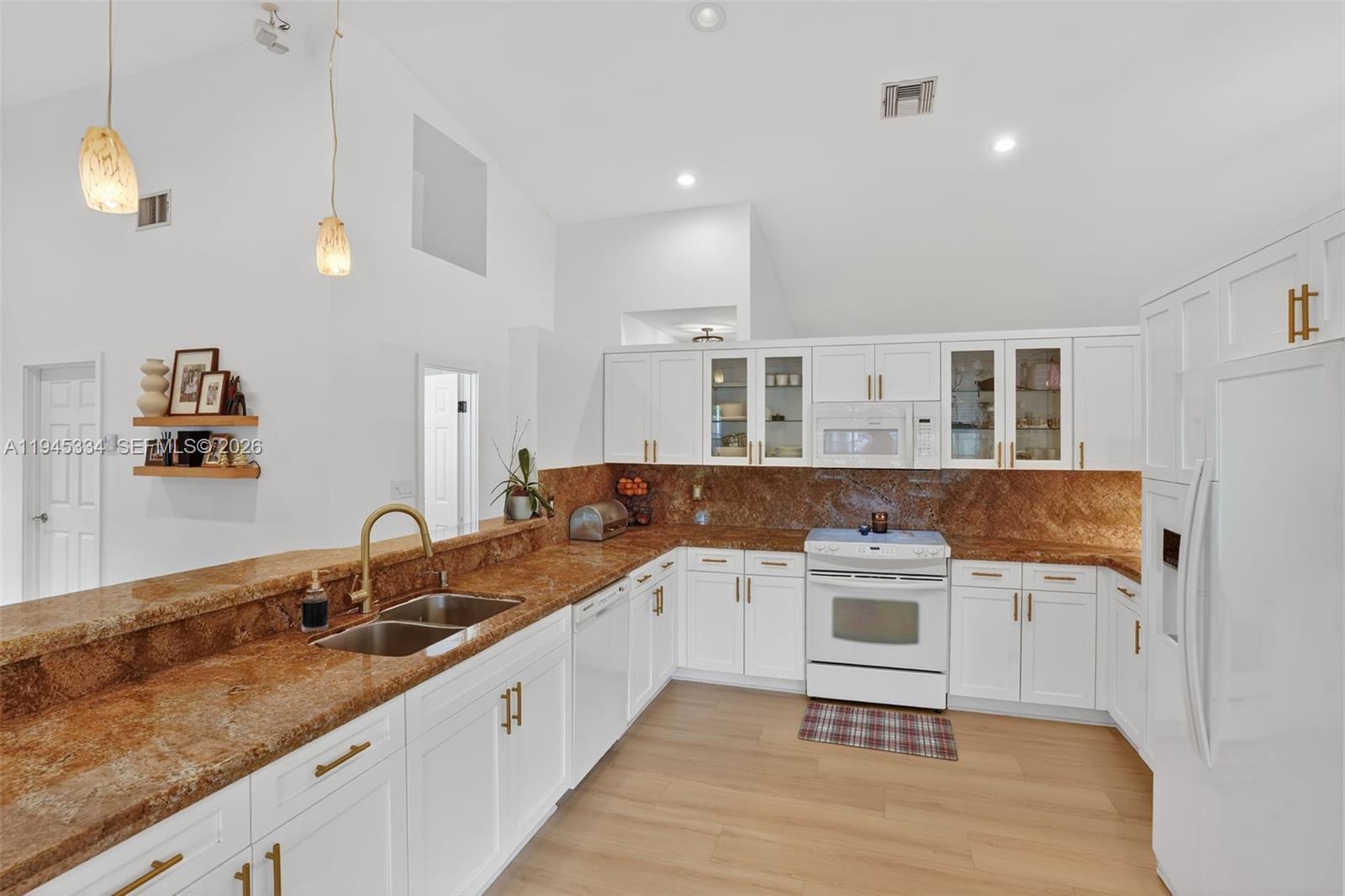 12200 Southwest 100th Street Miami, FL 33186 - Photo 11 of 48 a kitchen with a sink stove and cabinets