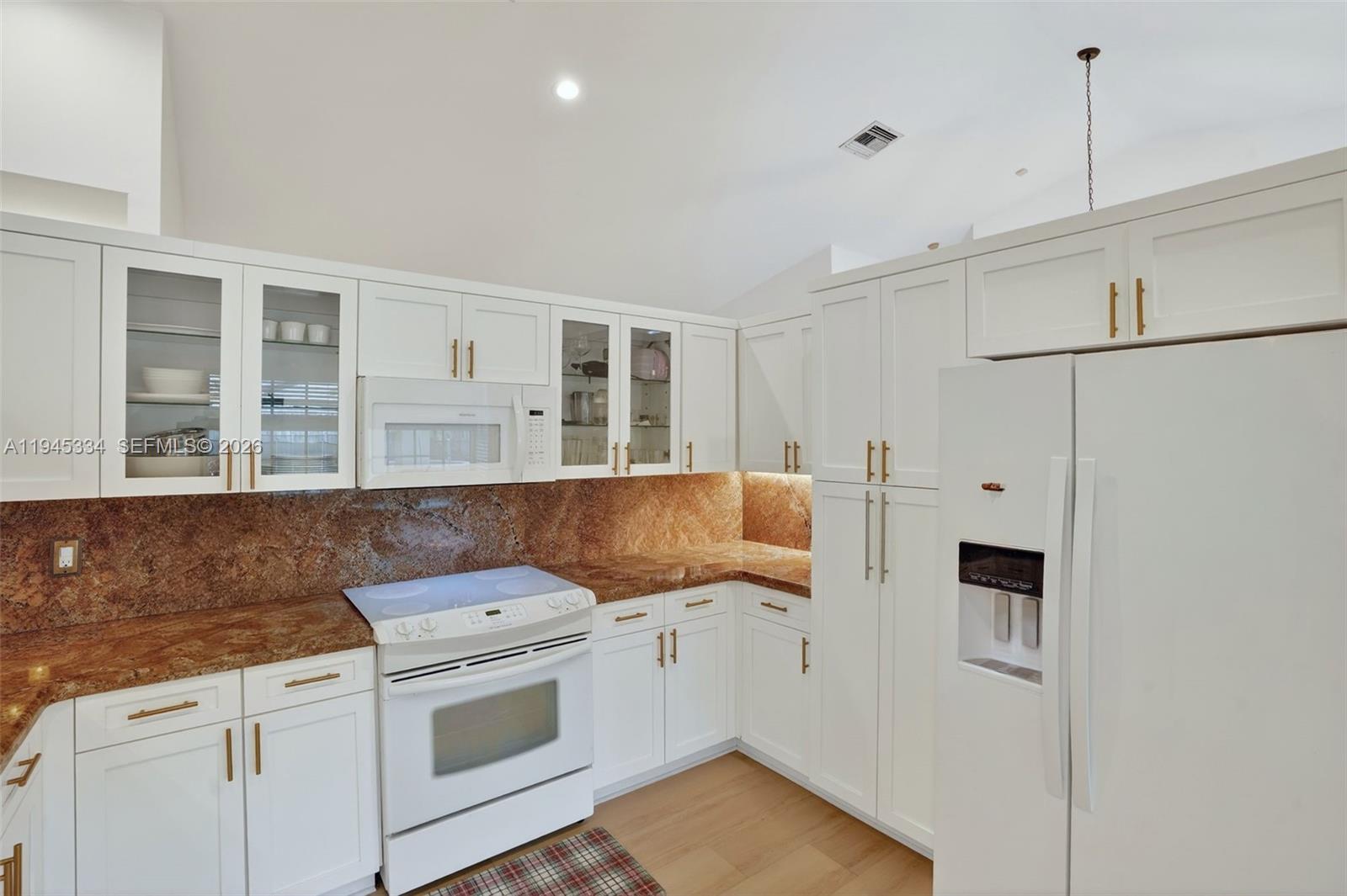 12200 Southwest 100th Street Miami, FL 33186 - Photo 12 of 48 a kitchen with stainless steel appliances granite countertop a stove a sink and a refrigerator