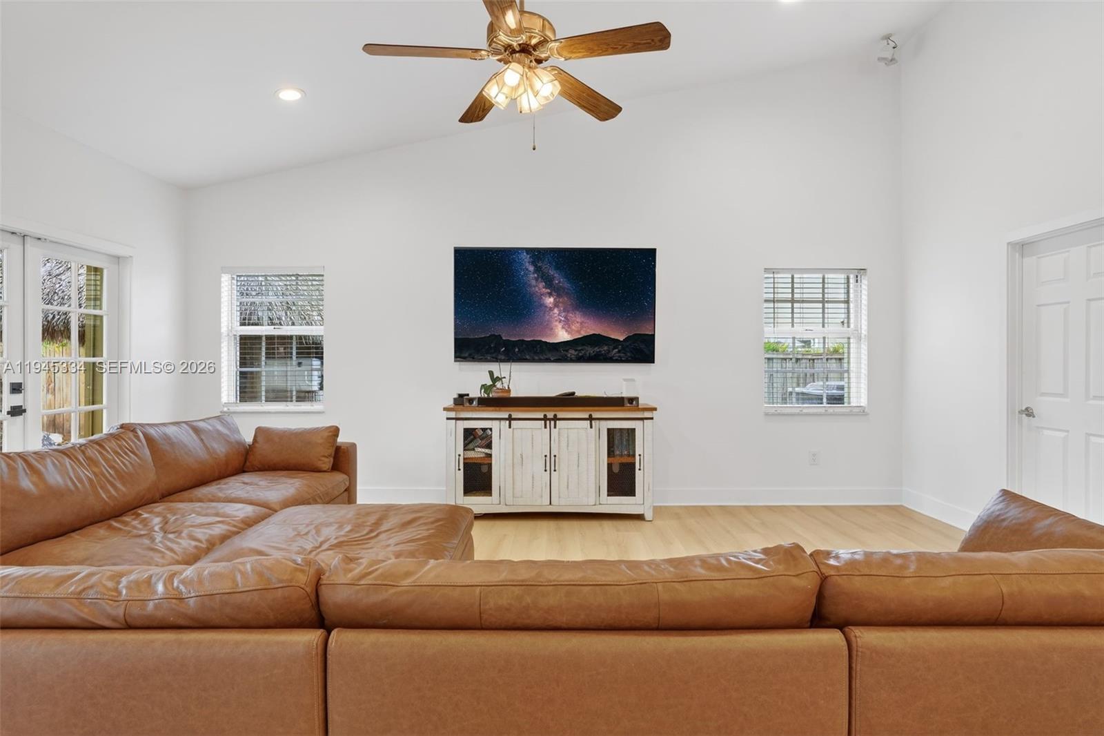 12200 Southwest 100th Street Miami, FL 33186 - Photo 14 of 48 a living room with furniture and a flat screen tv