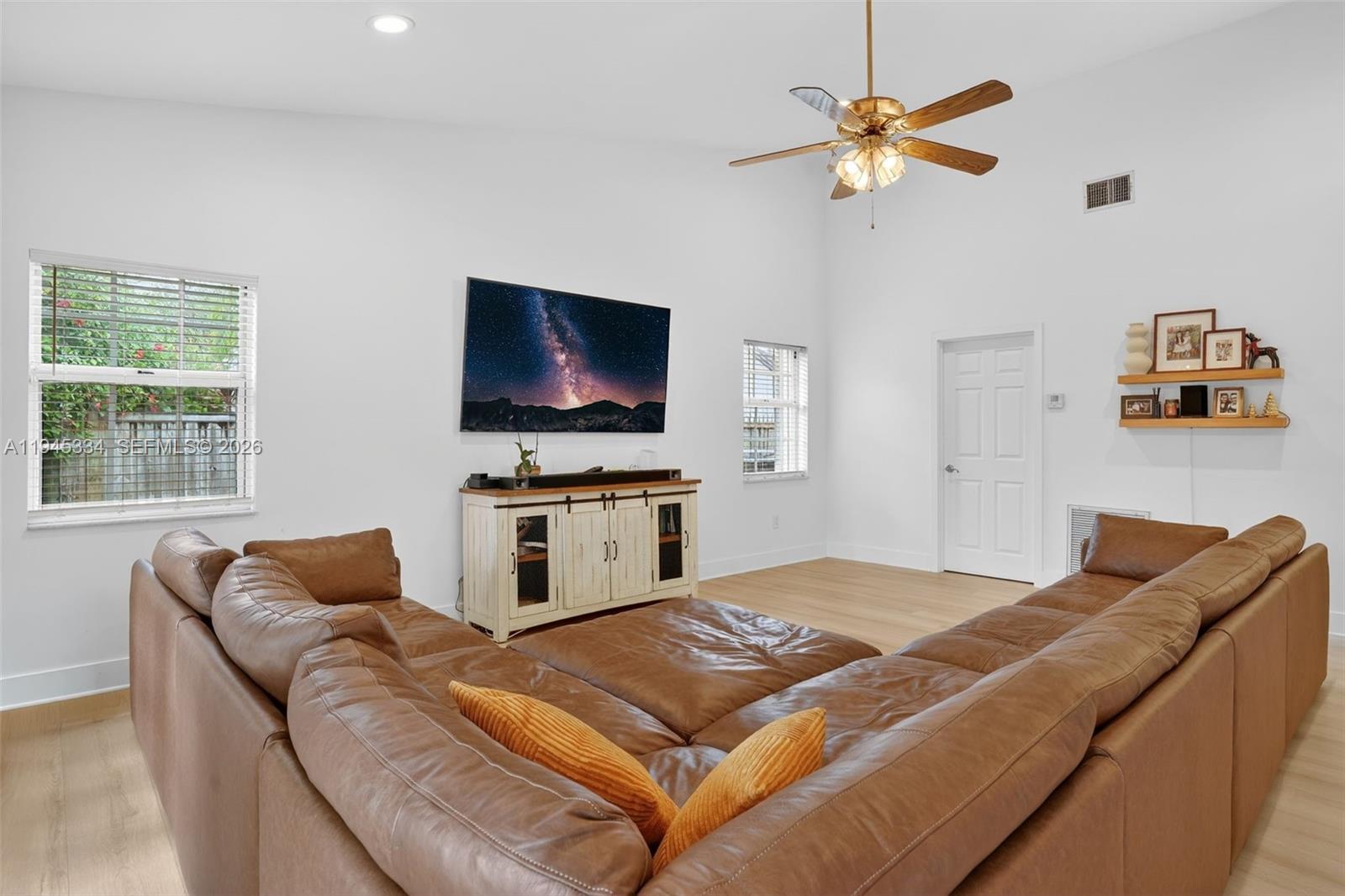 12200 Southwest 100th Street Miami, FL 33186 - Photo 15 of 48 a living room with furniture and a flat screen tv