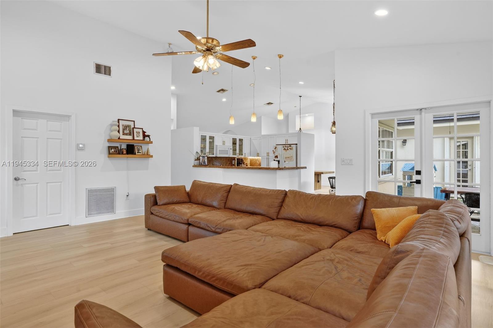12200 Southwest 100th Street Miami, FL 33186 - Photo 16 of 48 a living room with furniture and a chandelier