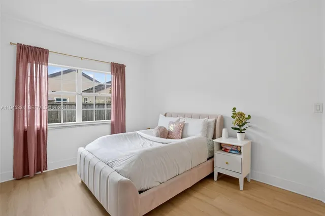 a bedroom with furniture and wooden floor