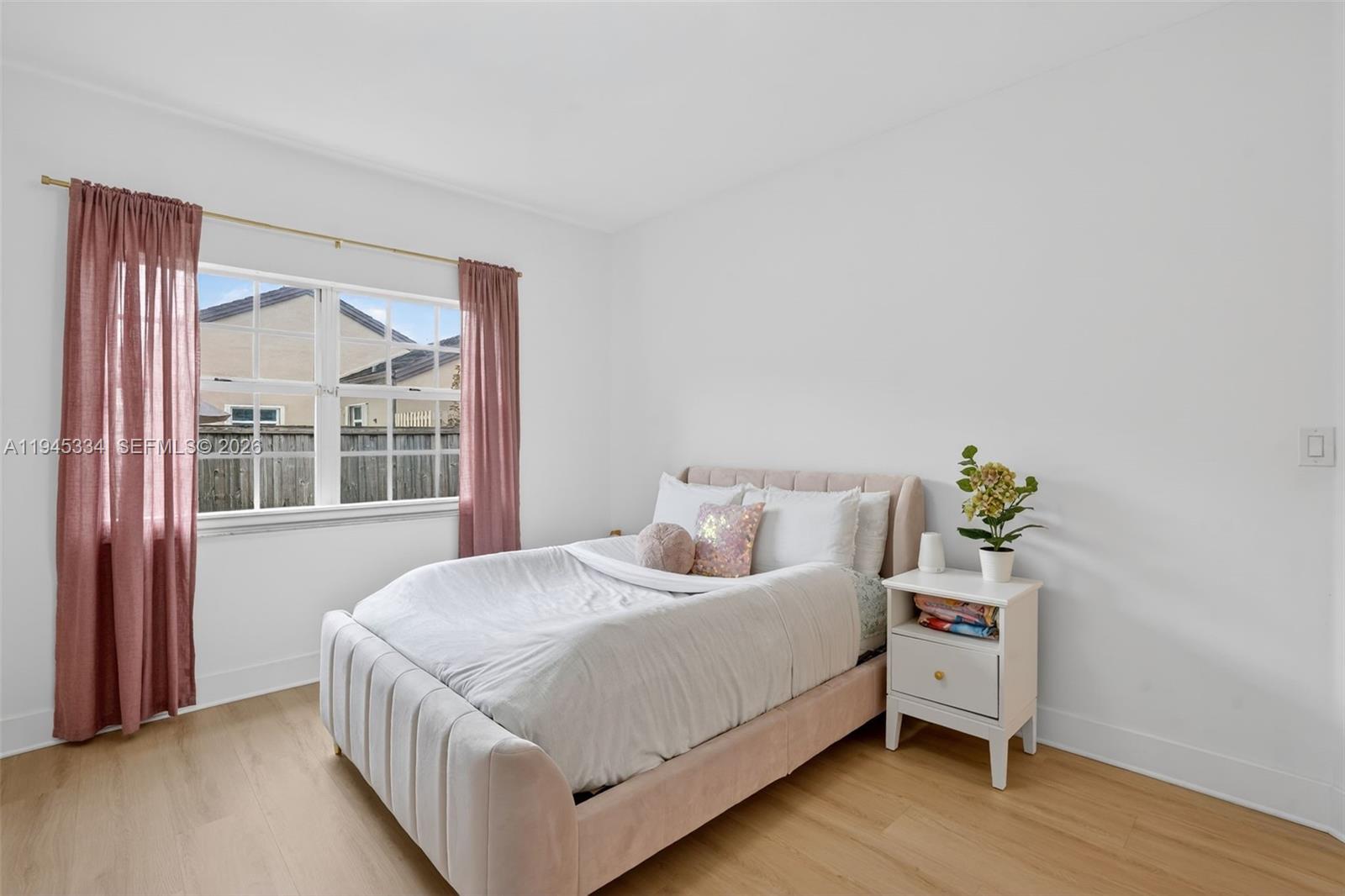 12200 Southwest 100th Street Miami, FL 33186 - Photo 21 of 48 a bedroom with a bed and a window