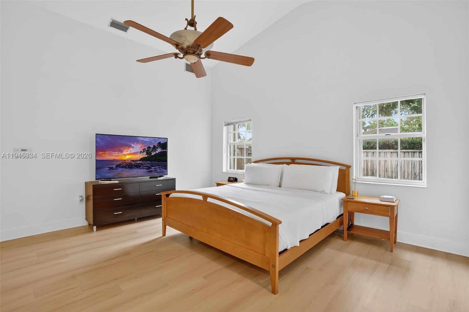 12200 Southwest 100th Street Miami, FL 33186 - Photo 29 of 48 a bedroom with a bed and a flat tv screen on dresser