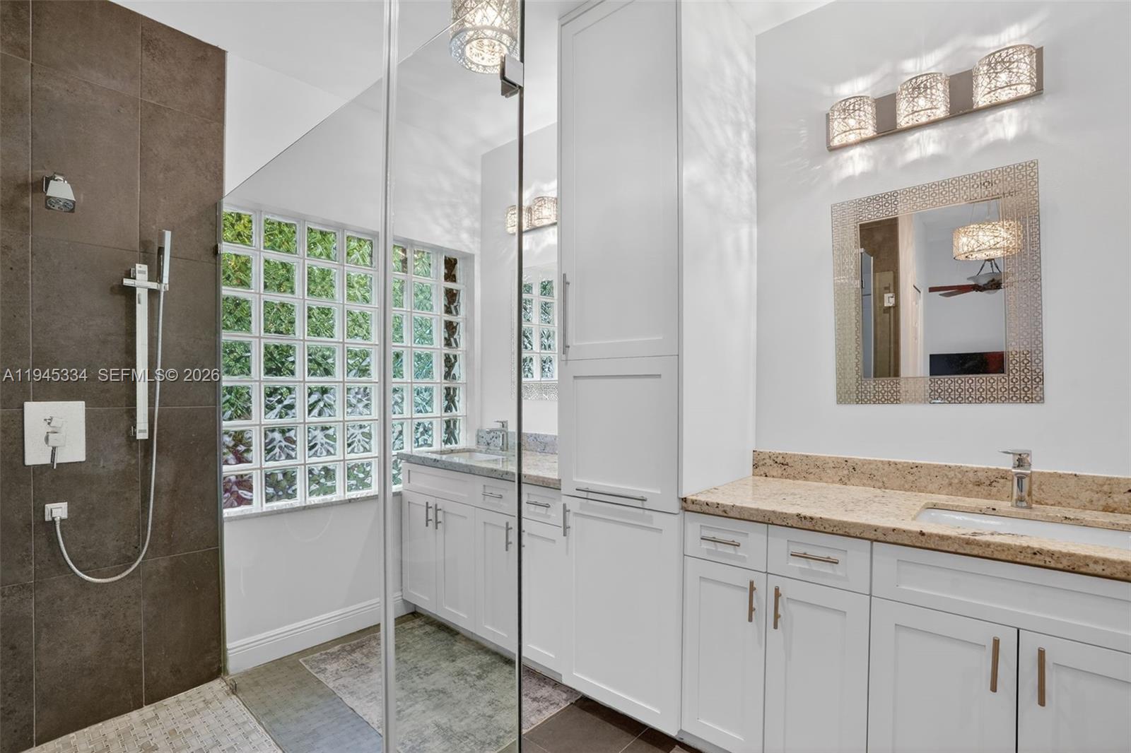 12200 Southwest 100th Street Miami, FL 33186 - Photo 31 of 48 a bathroom with a granite countertop shower a mirror and a sink