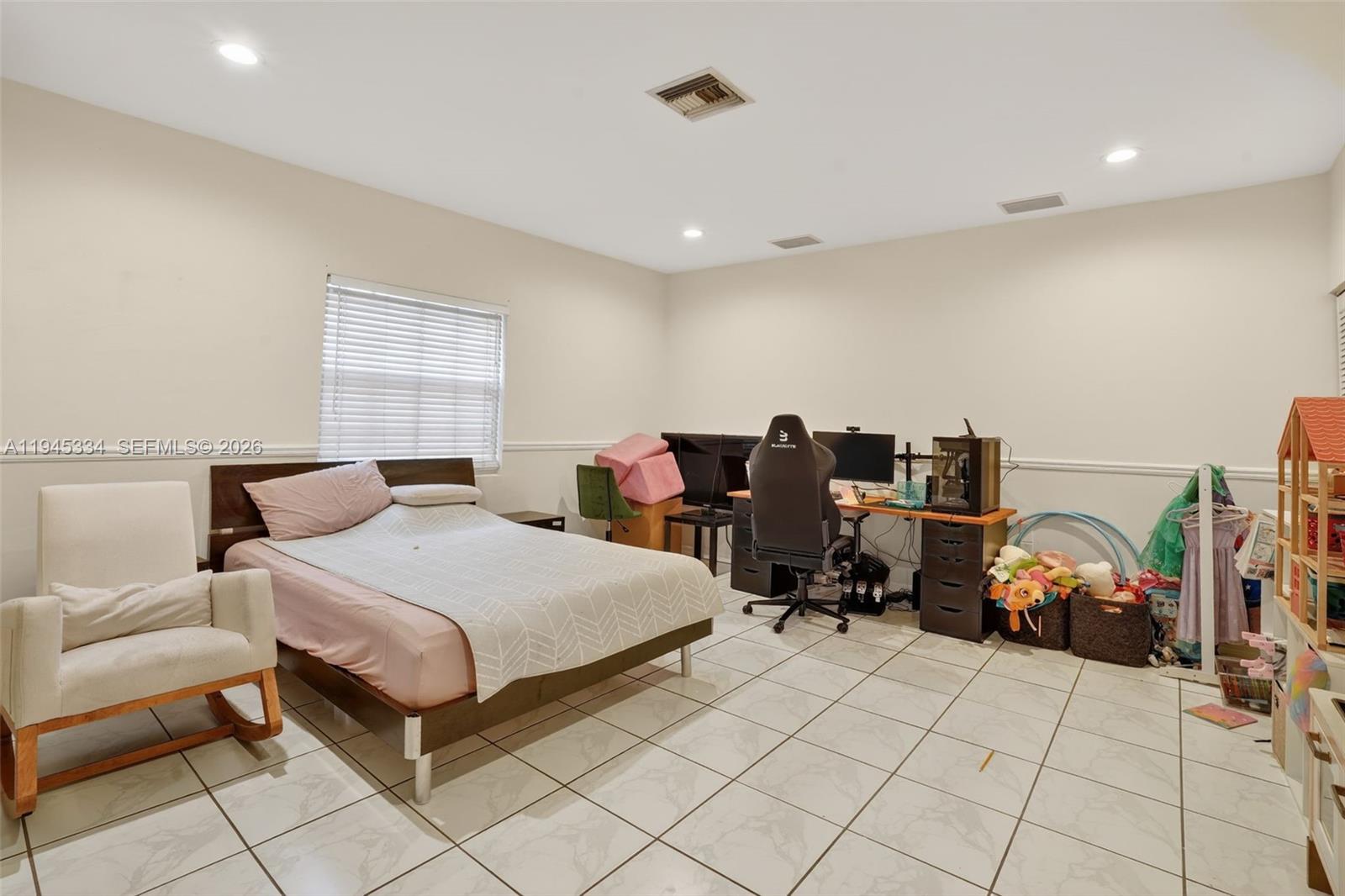 12200 Southwest 100th Street Miami, FL 33186 - Photo 34 of 48 a bedroom with a bed and a couch