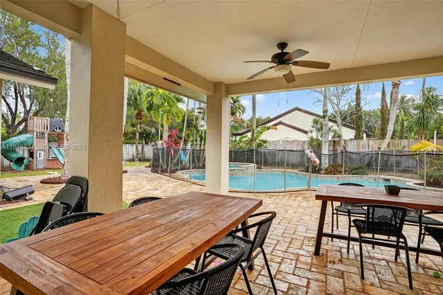 a view of a porch with furniture and garden