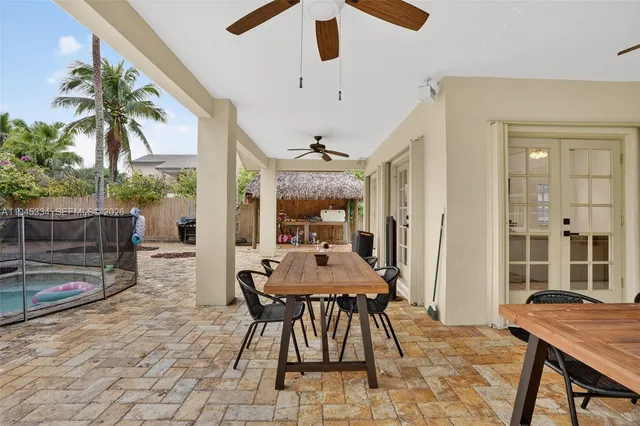 a view of a house with backyard and sitting area