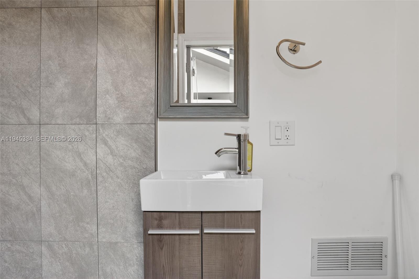 12200 Southwest 100th Street Miami, FL 33186 - Photo 41 of 48 a bathroom with a sink and a mirror