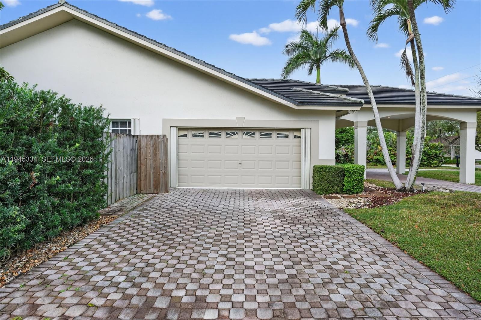 12200 Southwest 100th Street Miami, FL 33186 - Photo 43 of 48 a front view of a house with a yard and garage