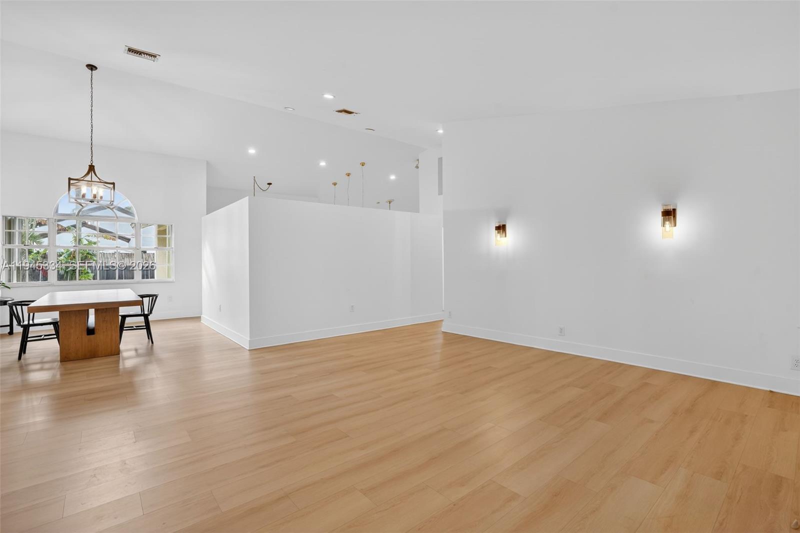 12200 Southwest 100th Street Miami, FL 33186 - Photo 6 of 48 a view of empty room with wooden floor and furniture