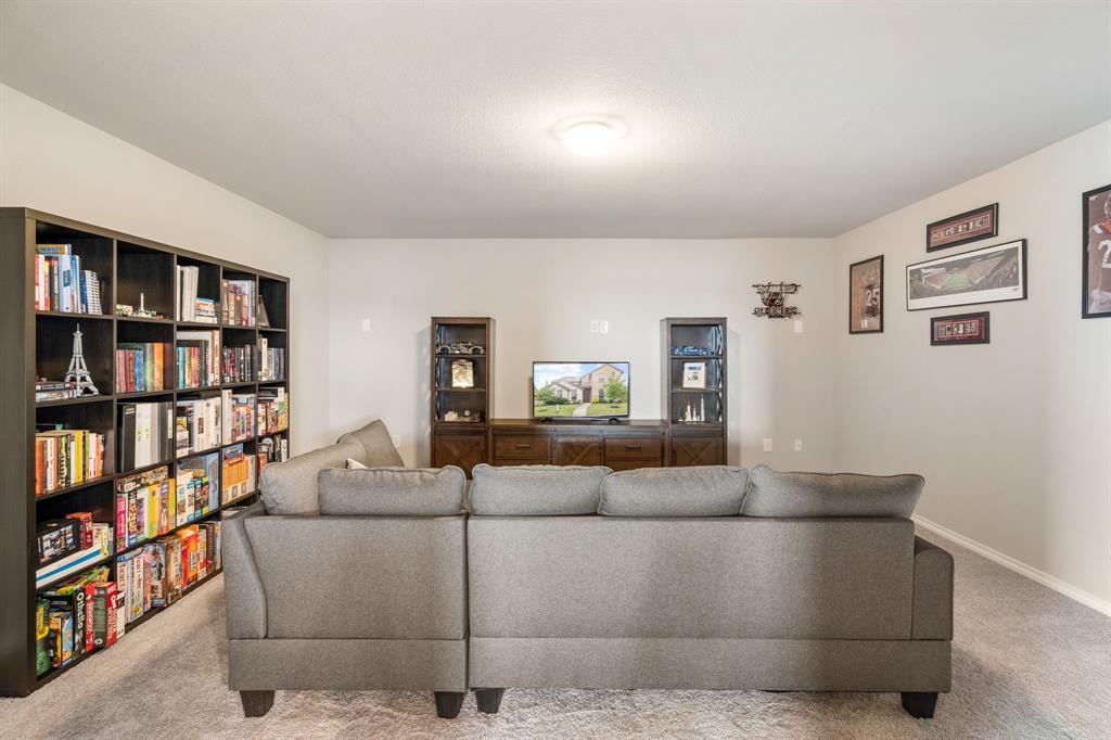 321 Pasture Drive Midlothian, TX 76065 - Photo 25 of 40 a living room with furniture and a book shelf