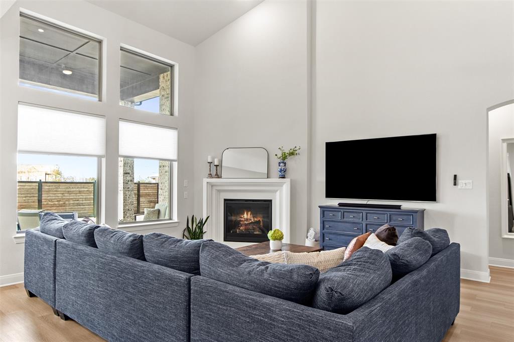 2708 Darlington Road Northlake, TX 76226 - Photo 8 of 40 a living room with furniture a fireplace and a flat screen tv