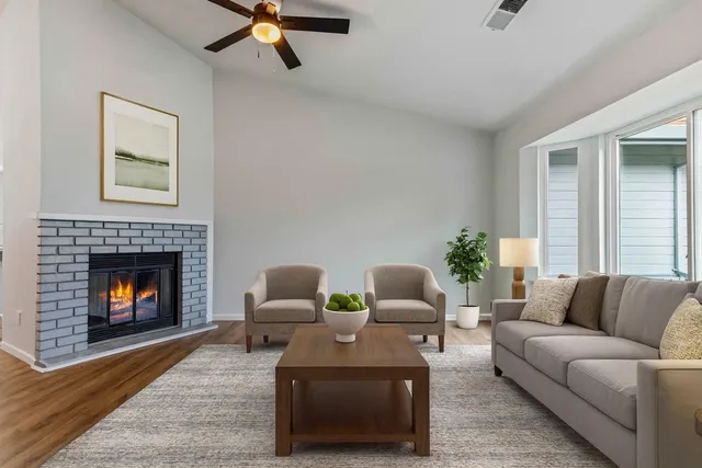 a living room with furniture and a fireplace