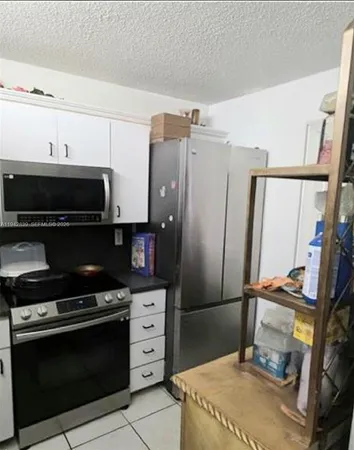a kitchen with stainless steel appliances a stove a microwave and a refrigerator