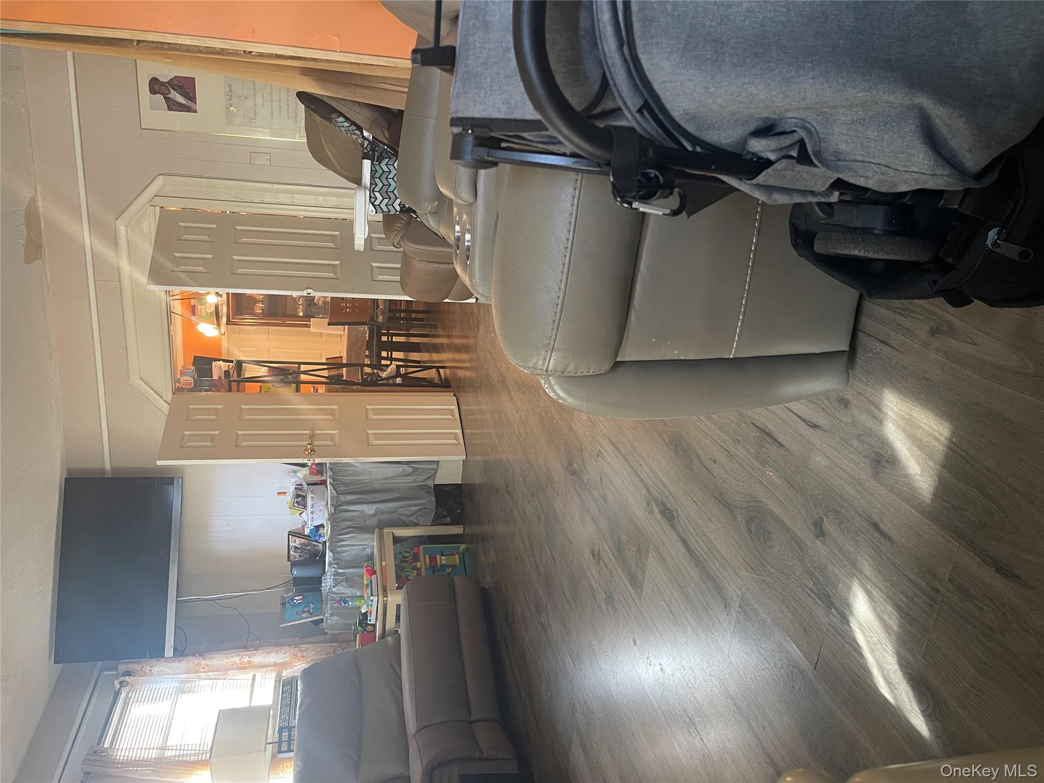 197-13 118th Avenue Queens, NY 11412 - Photo 2 of 5 a living room with furniture and a table