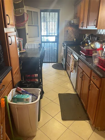 a kitchen with stainless steel appliances a stove a sink a refrigerator a window