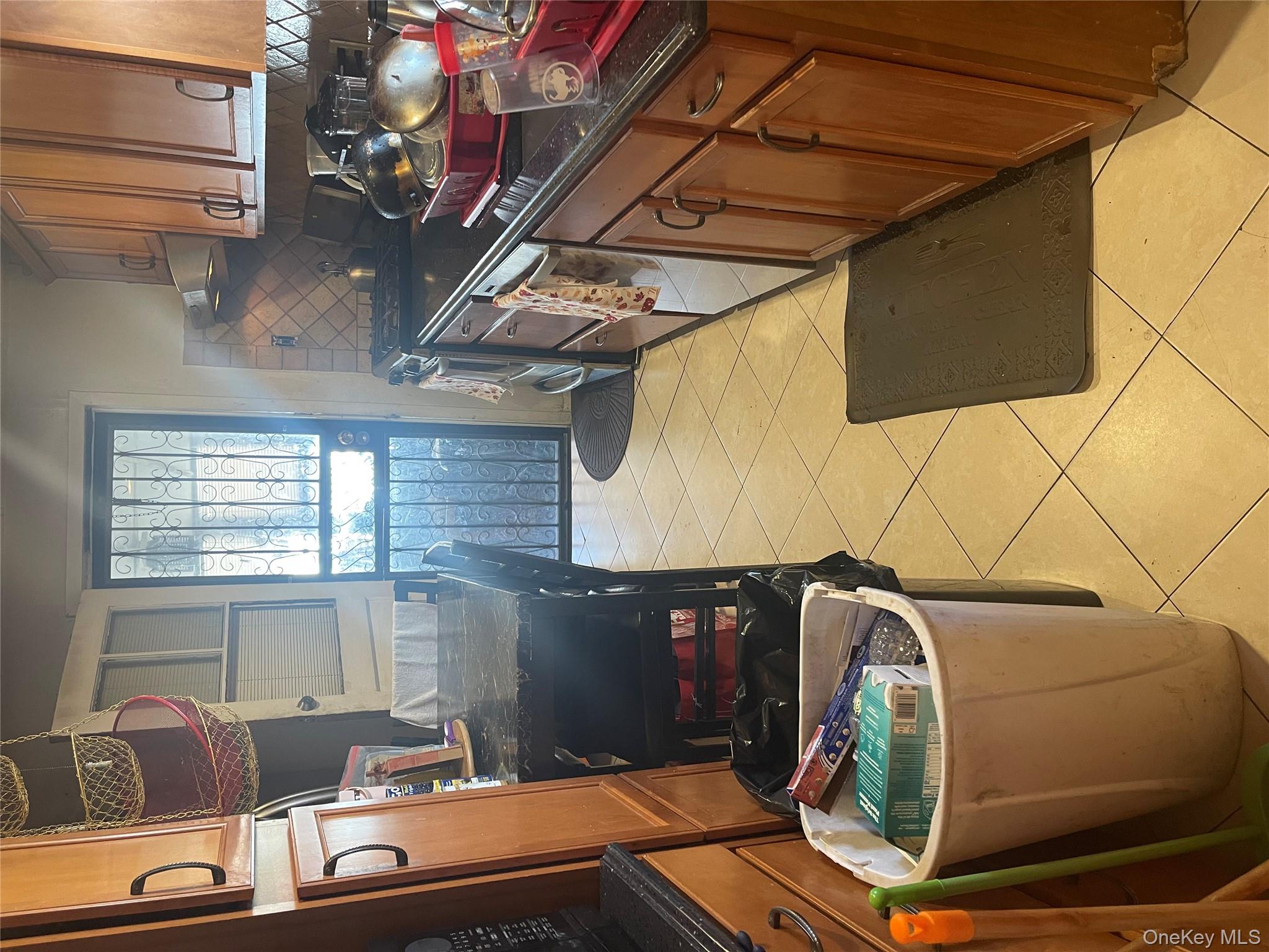 197-13 118th Avenue Queens, NY 11412 - Photo 3 of 5 a kitchen with stainless steel appliances a stove a sink a refrigerator a window