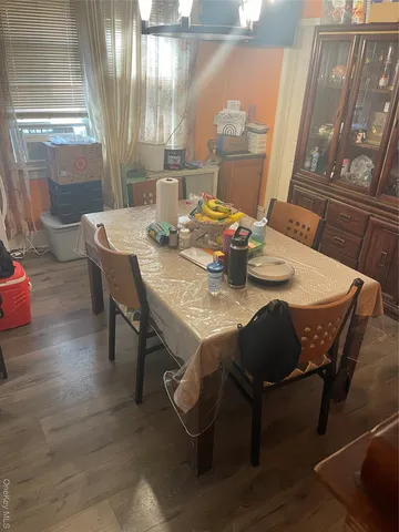 a dining room with furniture and wooden floor