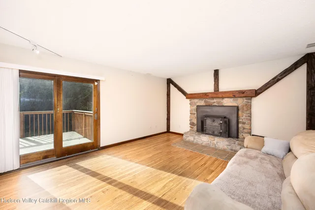 a view of a livingroom with a fireplace and glass door