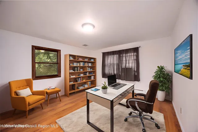 a view of a livingroom with furniture and a potted plant