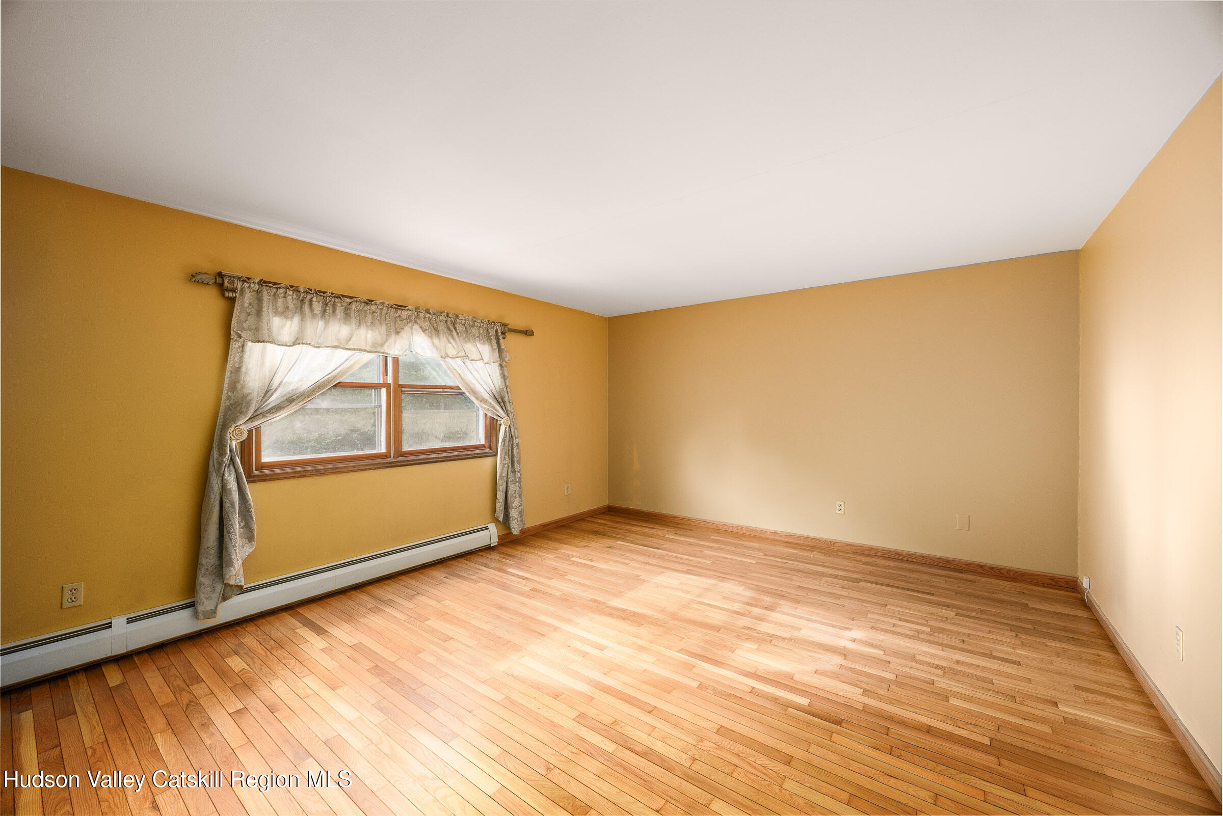 94 Tanglewood Road West Hurley, NY 12491 - Photo 18 of 34 an empty room with wooden floor and door