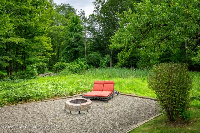 a blue bench sitting in the middle of a garden