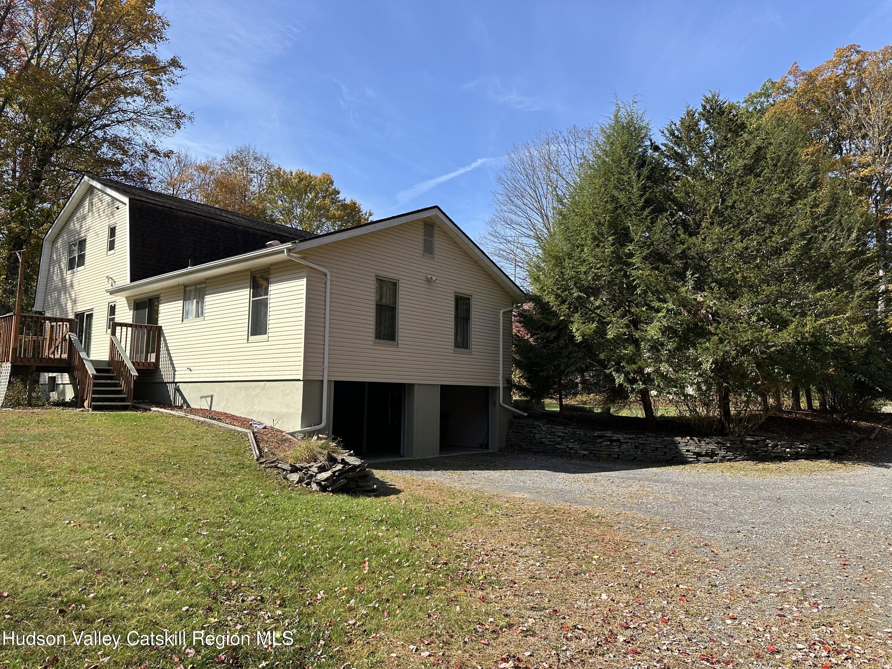 94 Tanglewood Road West Hurley, NY 12491 - Photo 3 of 34 a view of a house with backyard and a tree