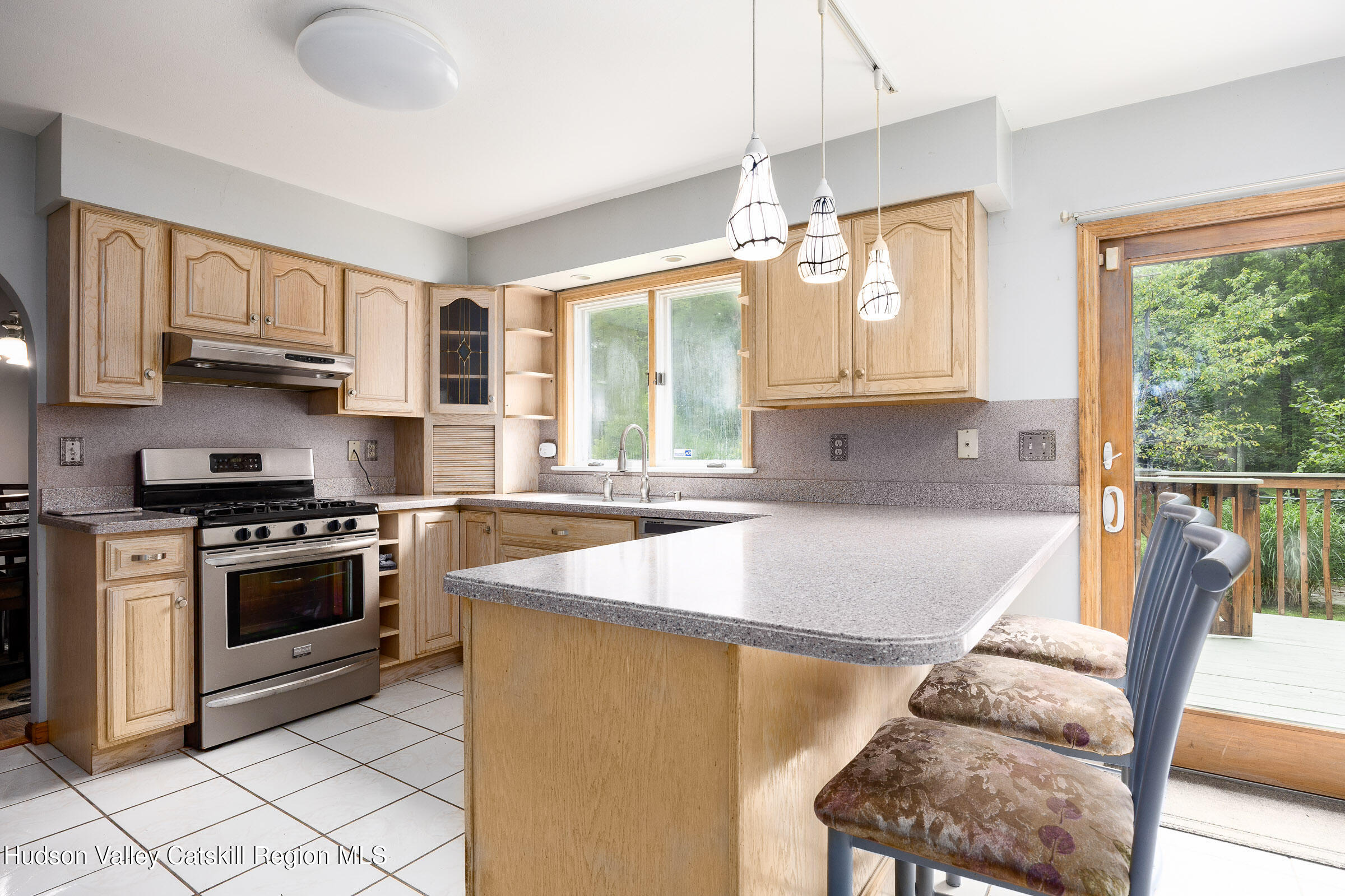 94 Tanglewood Road West Hurley, NY 12491 - Photo 8 of 34 a kitchen with stainless steel appliances granite countertop a stove a sink and a microwave