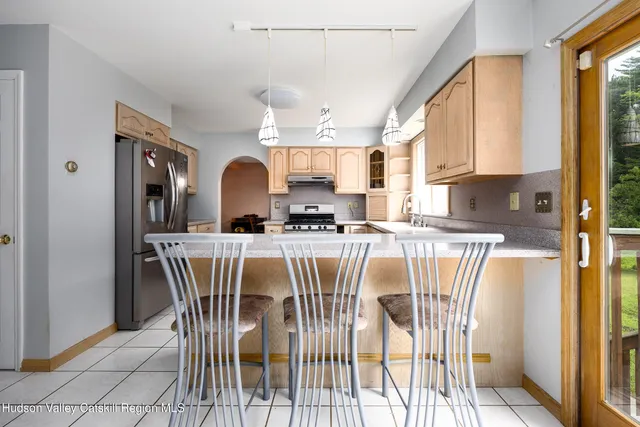 a view of a dining room with furniture and a window