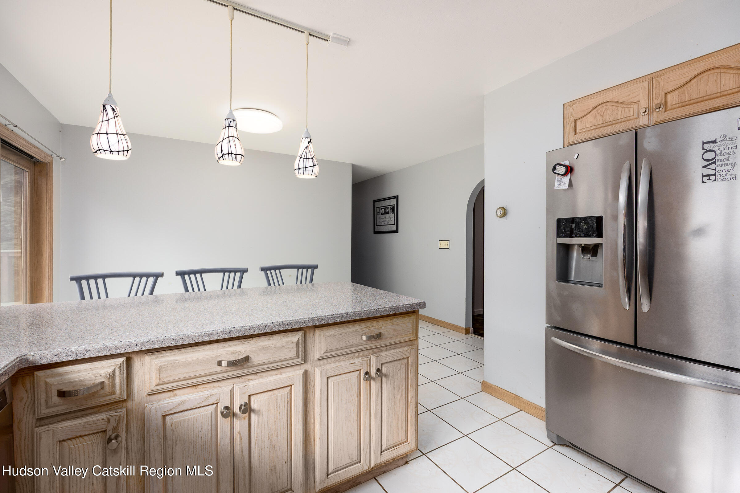94 Tanglewood Road West Hurley, NY 12491 - Photo 10 of 34 a kitchen with kitchen island a counter top a refrigerator and a sink