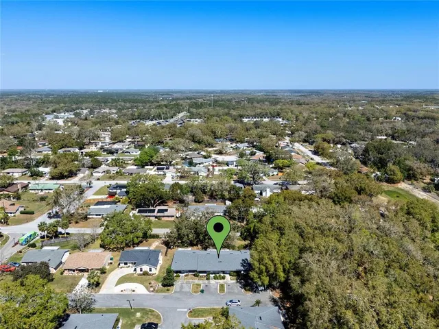 an aerial view of residential houses with city view