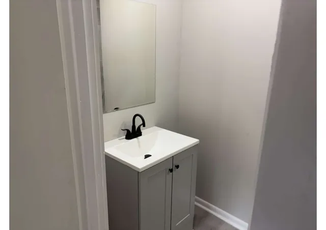 a bathroom with a sink and mirror