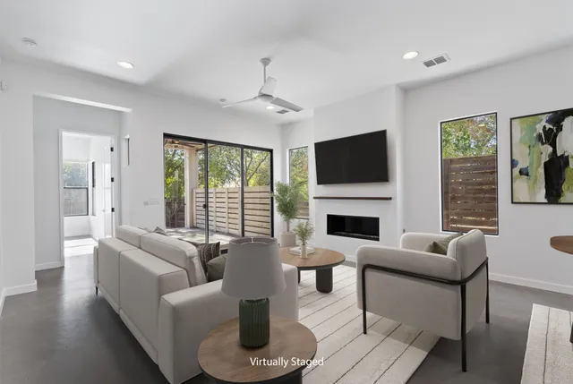 a view of a living room a fireplace with a window and wooden floor