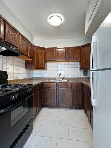 a kitchen with a stove top oven sink and cabinets