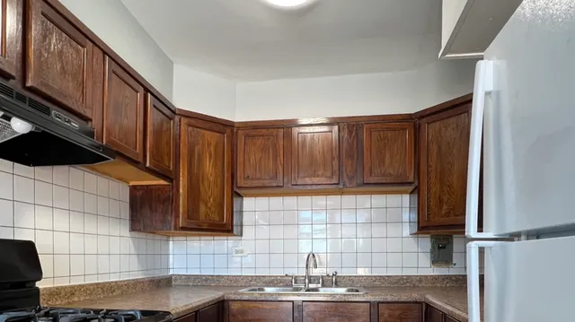 a kitchen with stainless steel appliances a sink a stove a microwave a sink and cabinets