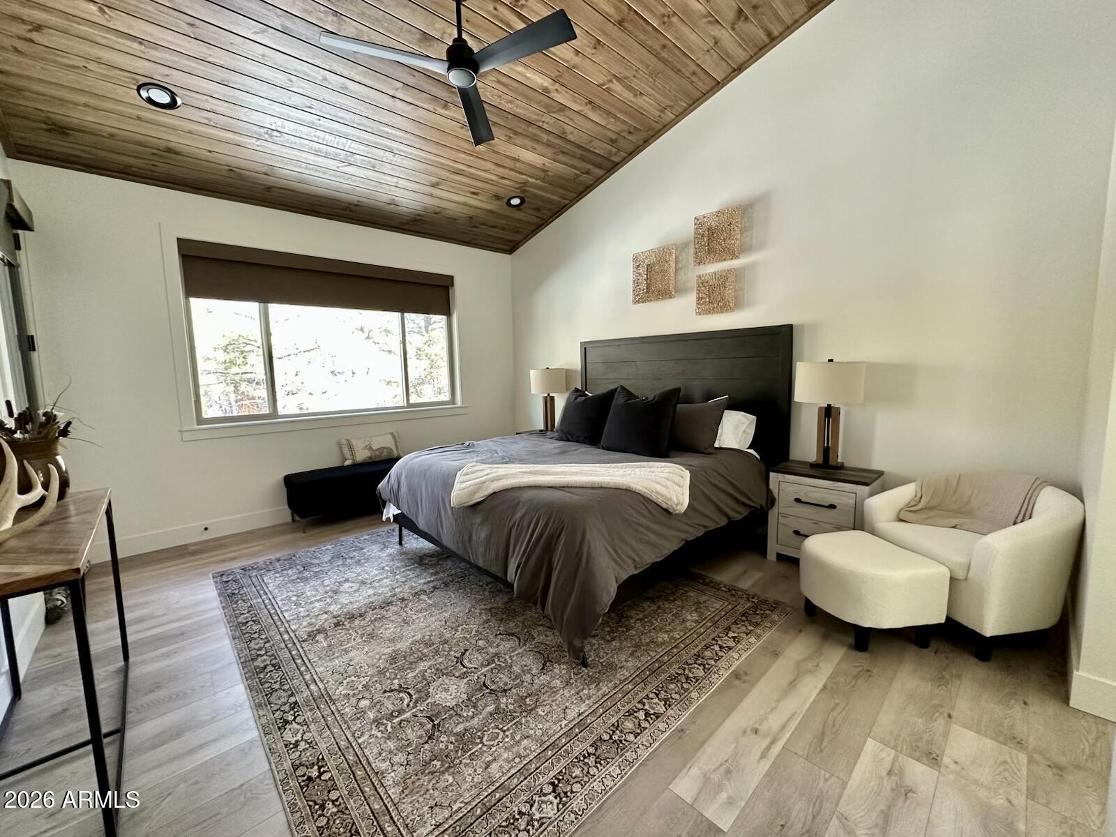 4260 West Falling Leaf Road Show Low, AZ 85901 - Photo 14 of 32 a spacious bedroom with a bed a couch and window