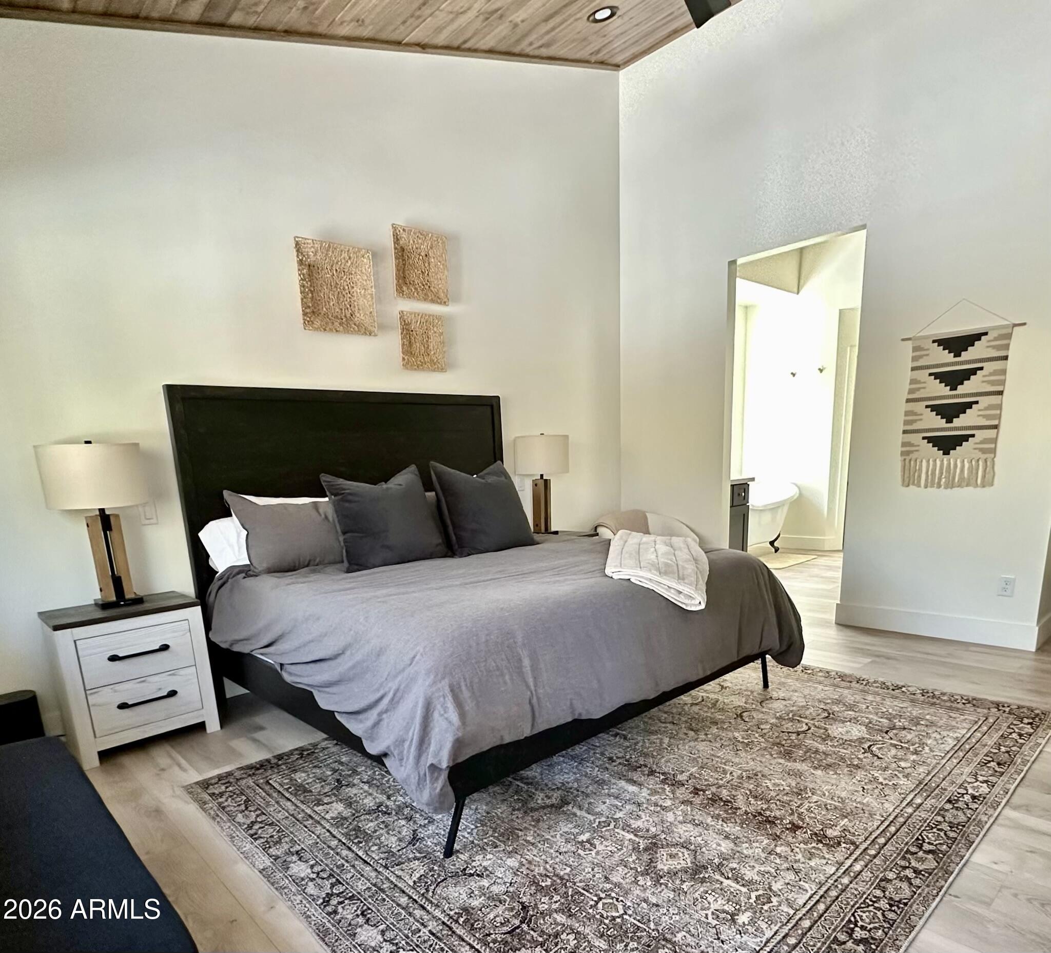 4260 West Falling Leaf Road Show Low, AZ 85901 - Photo 15 of 32 a bedroom with a bed and wooden floor