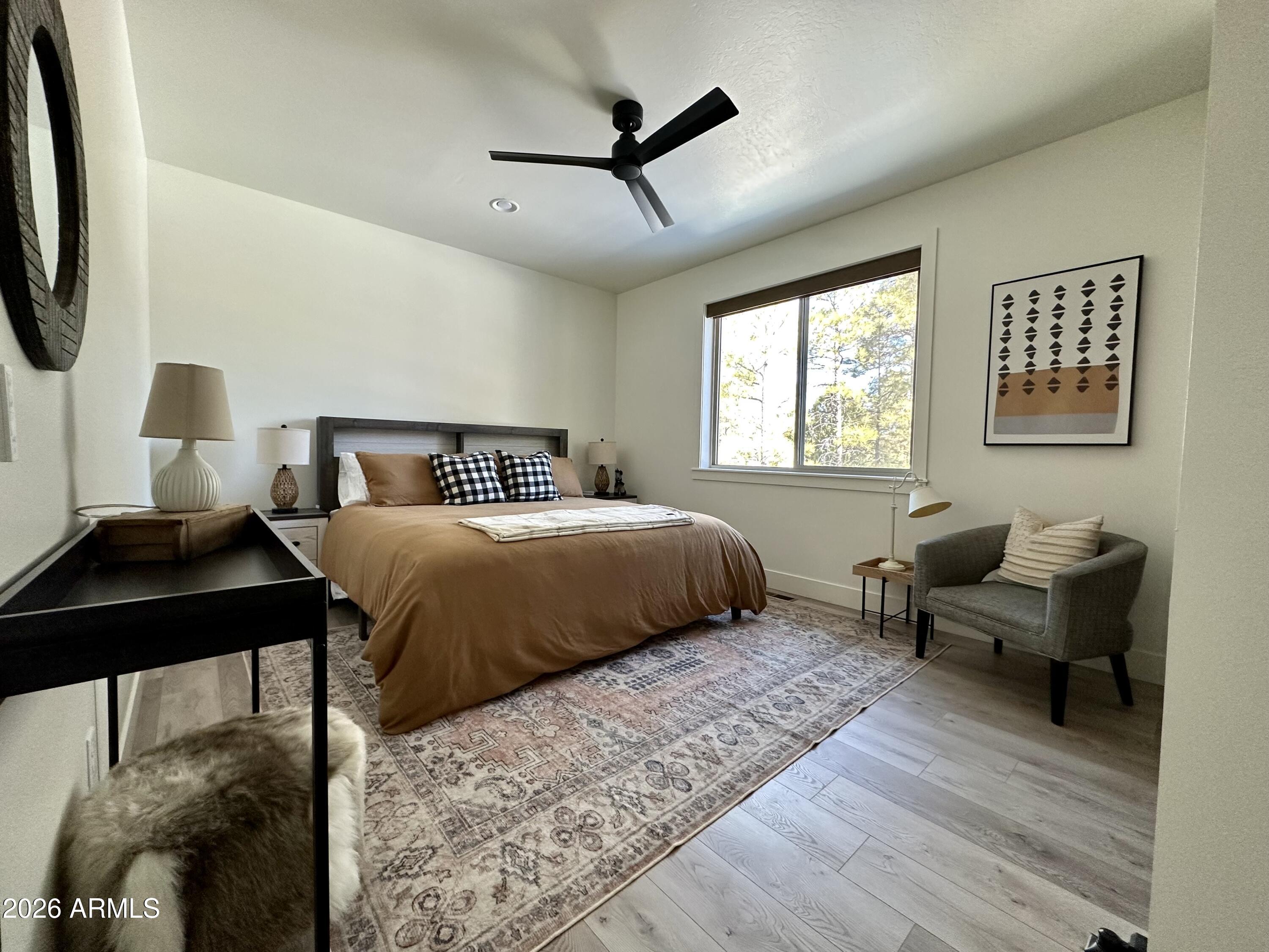 4260 West Falling Leaf Road Show Low, AZ 85901 - Photo 18 of 32 a bedroom with a bed a couch and a window