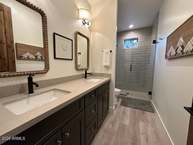 4260 West Falling Leaf Road Show Low, AZ 85901 - Photo 19 of 32 a bathroom with a double vanity sink a toilet and shower